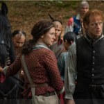 Claire and Jamie Fraser stand by a horse